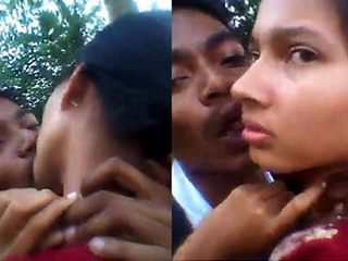 Romantic couple smooching fervently in an open-air setting