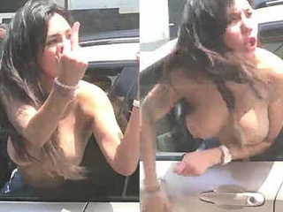 girl goes braless and  in a car on a active street