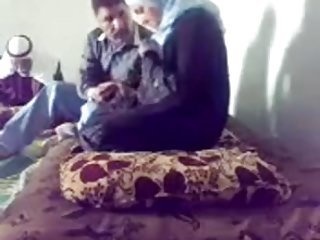 Doctor visits a gal with headscarf in the family