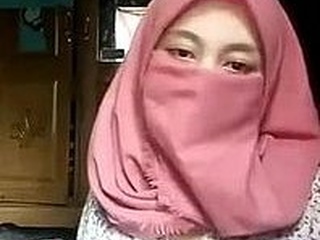 A nymph wearing a hijab strips on webcam